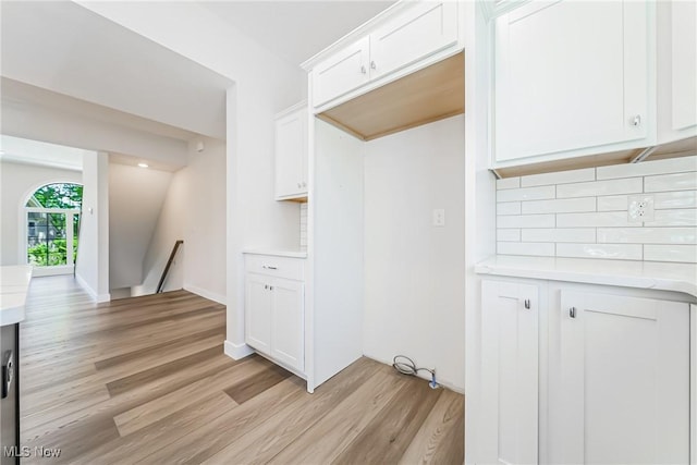 laundry area with light hardwood / wood-style flooring