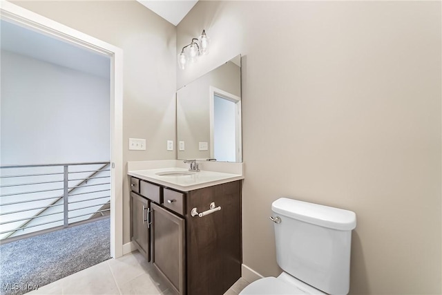 bathroom with toilet, tile patterned floors, and vanity