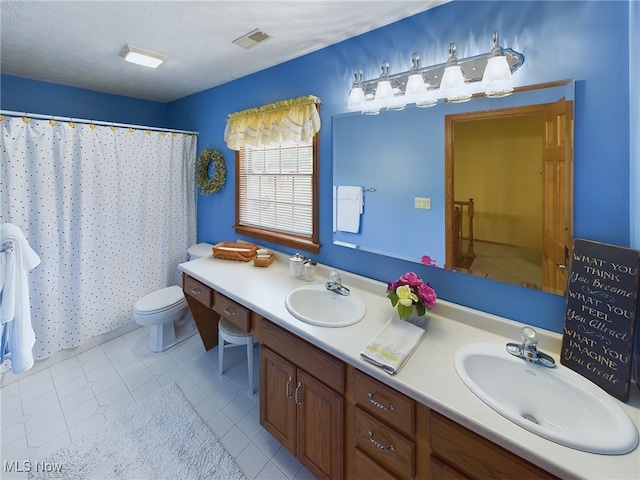 bathroom with toilet, tile patterned floors, a shower with curtain, vanity, and a textured ceiling