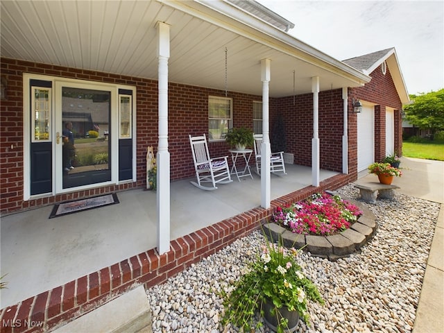 view of patio / terrace featuring a garage and covered porch