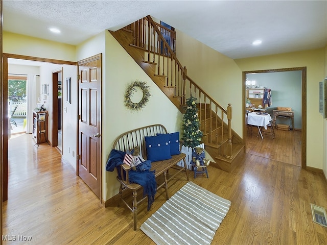 interior space featuring a textured ceiling and hardwood / wood-style floors