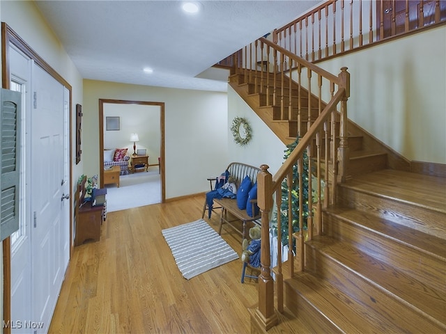 stairs featuring hardwood / wood-style flooring