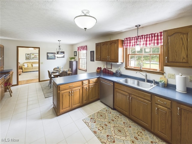 kitchen with dishwasher, kitchen peninsula, a textured ceiling, pendant lighting, and sink