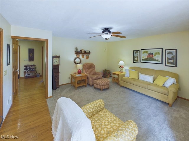 living room featuring ceiling fan and light carpet