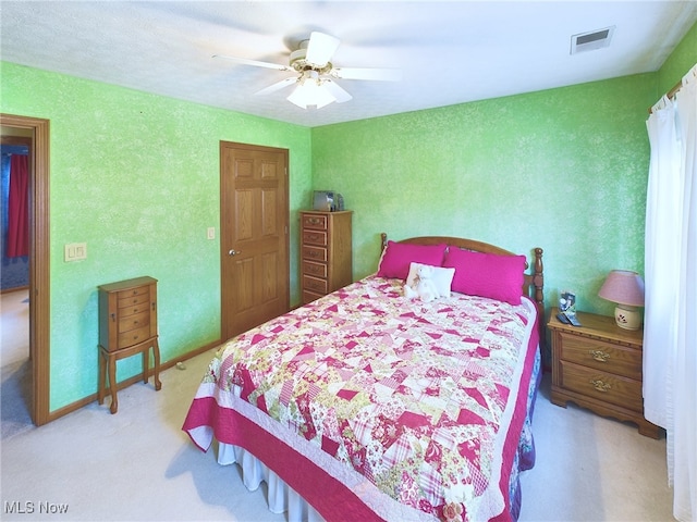 bedroom with light carpet and ceiling fan