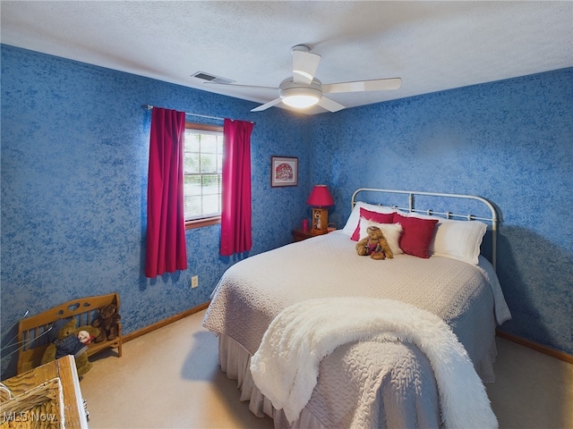 bedroom with a textured ceiling and ceiling fan