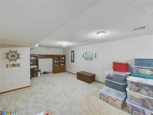 basement with a textured ceiling and carpet flooring