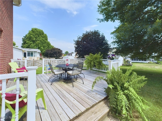 wooden terrace with a yard