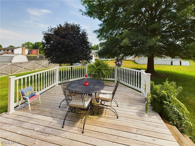 wooden deck featuring a yard