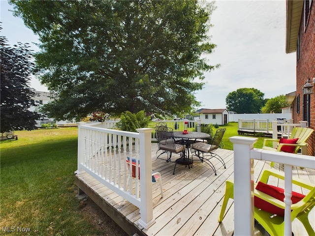 wooden deck with a lawn