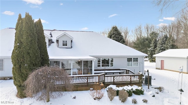 snow covered property with a deck