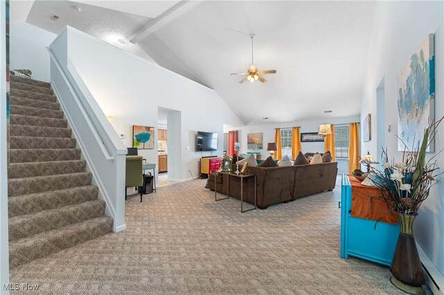 carpeted living room featuring ceiling fan and high vaulted ceiling