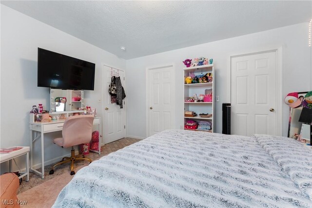 carpeted bedroom with a textured ceiling