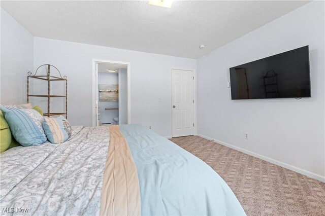 carpeted bedroom featuring connected bathroom