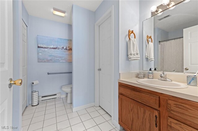 bathroom with toilet, baseboard heating, tile patterned floors, and vanity