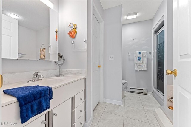 bathroom featuring tile patterned flooring, toilet, vanity, a shower with shower door, and a baseboard radiator