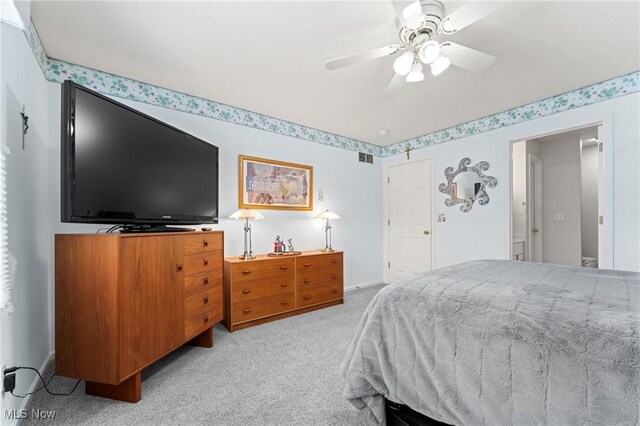 bedroom with light carpet and ceiling fan