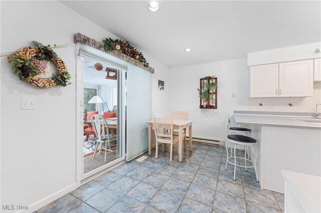 unfurnished dining area with sink and a baseboard radiator