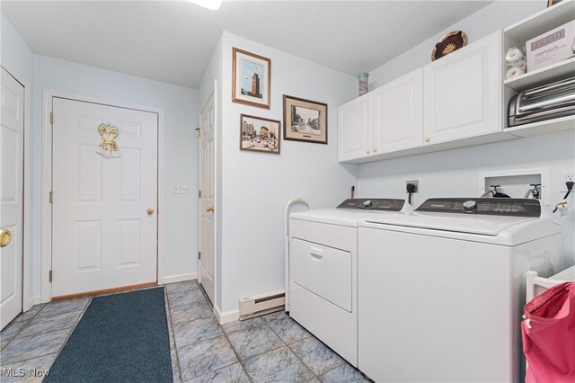 laundry room featuring a baseboard heating unit, cabinets, and washer and clothes dryer