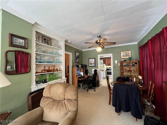 office featuring light carpet, ceiling fan, and ornamental molding