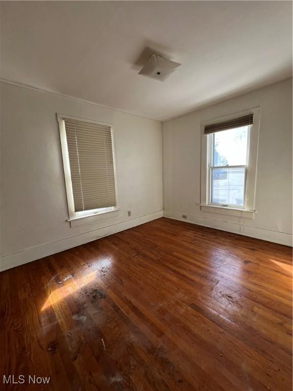 empty room with dark hardwood / wood-style floors