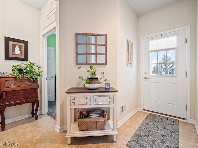 foyer featuring light tile patterned flooring