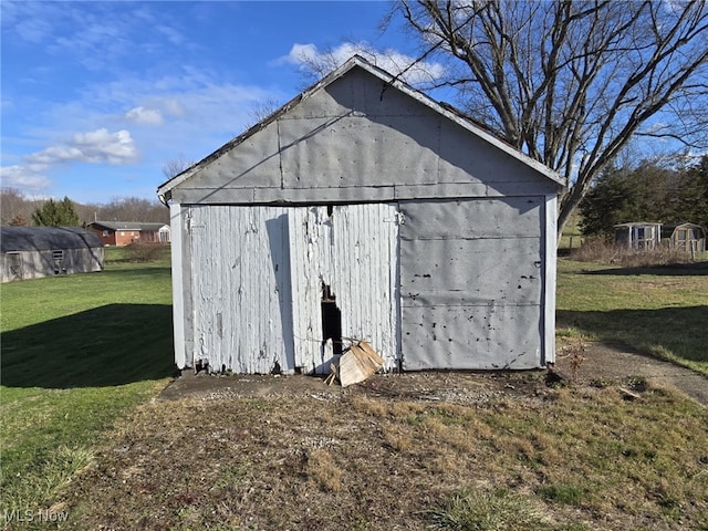 view of outbuilding featuring a yard