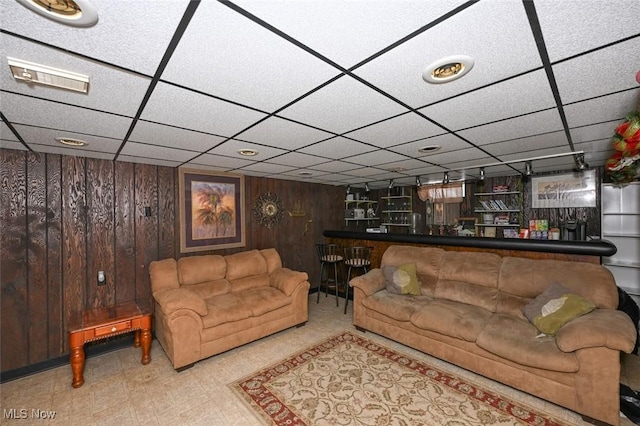 living room with wood walls and indoor bar