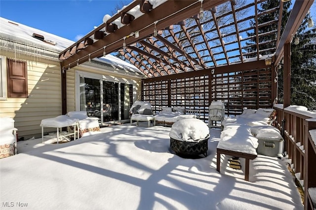 snow covered patio featuring a pergola