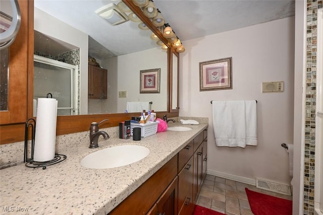 bathroom featuring an enclosed shower and vanity