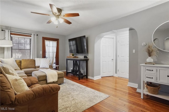 living room with ceiling fan and light hardwood / wood-style floors