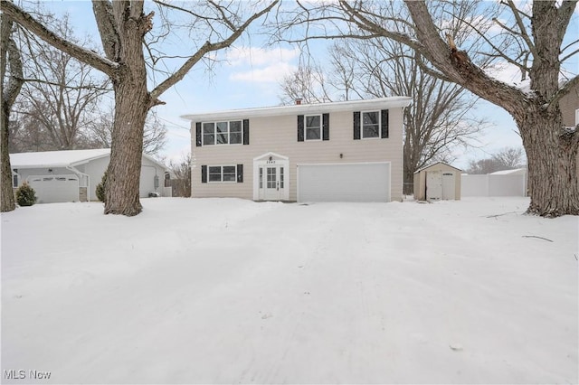 view of front of home with a garage and a storage shed