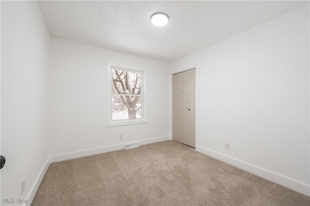 spare room with light colored carpet