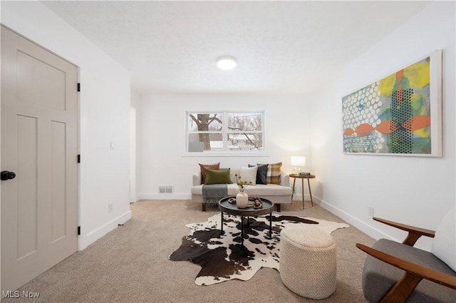 sitting room with light colored carpet