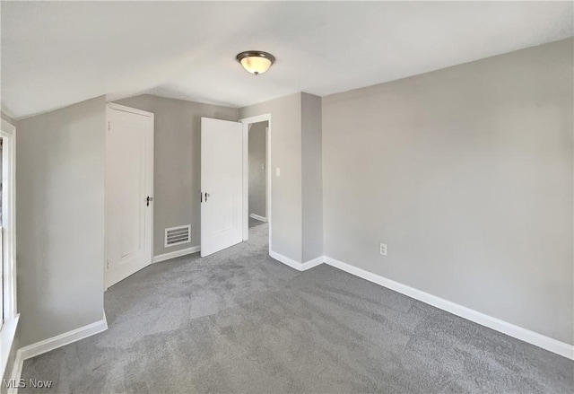 interior space with vaulted ceiling and carpet floors