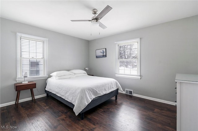 bedroom with ceiling fan and dark wood-type flooring