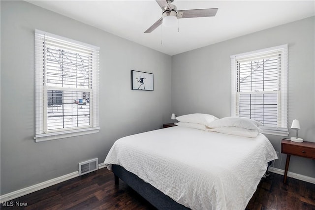 bedroom with dark hardwood / wood-style flooring and ceiling fan