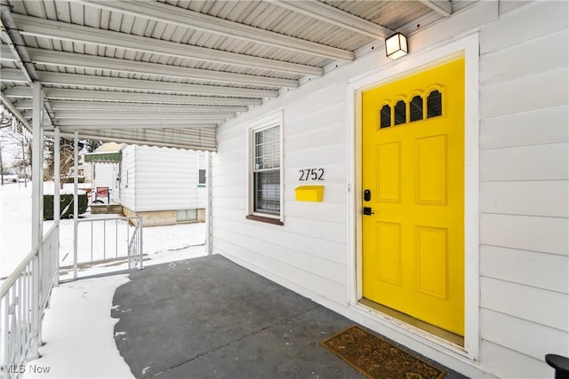 view of exterior entry featuring a porch