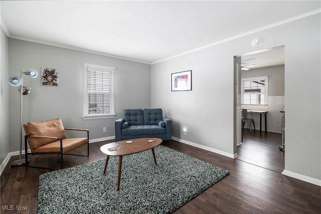 sitting room featuring ceiling fan, crown molding, and dark hardwood / wood-style floors