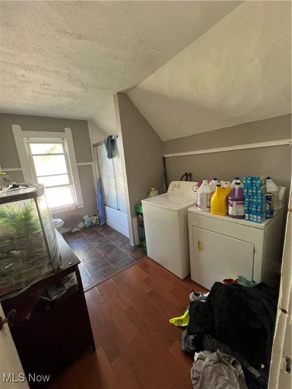 laundry room with washer and dryer and dark hardwood / wood-style floors