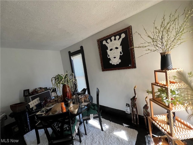 dining space with carpet flooring and a textured ceiling