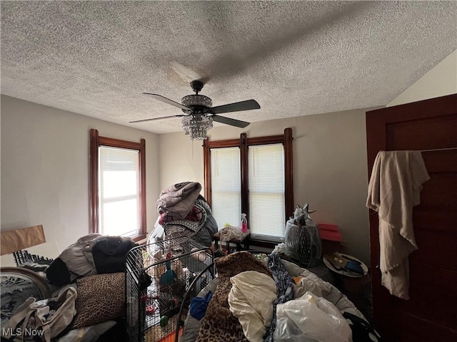 bedroom featuring a textured ceiling and ceiling fan