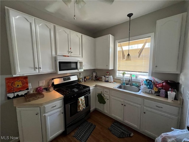 kitchen with appliances with stainless steel finishes, white cabinetry, and sink