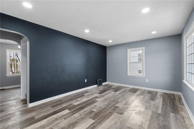 unfurnished room with ceiling fan and hardwood / wood-style flooring