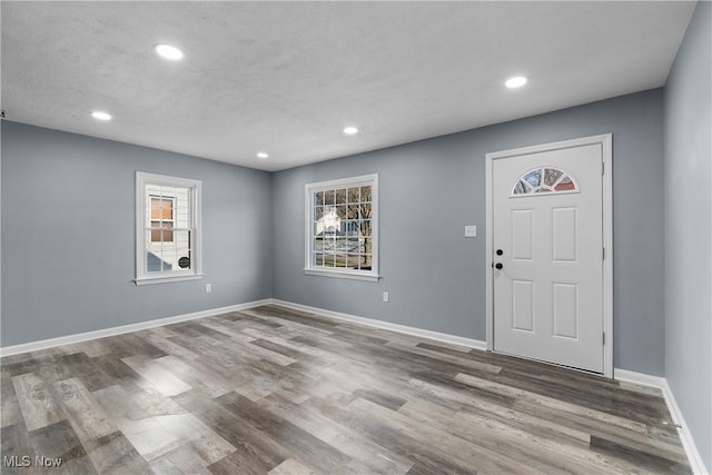 foyer with a textured ceiling and hardwood / wood-style flooring