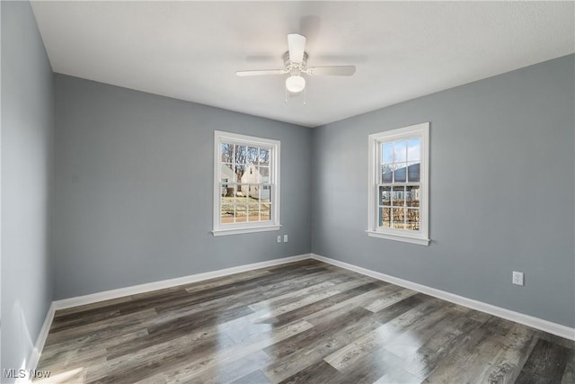 unfurnished room featuring ceiling fan and dark hardwood / wood-style floors