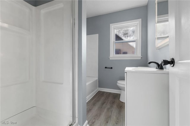 bathroom with hardwood / wood-style flooring, vanity, and toilet