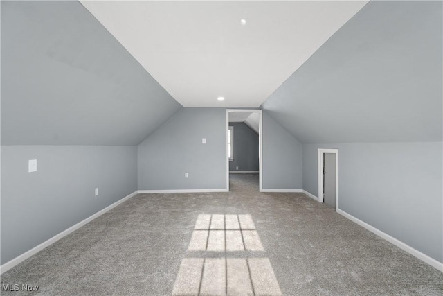 bonus room featuring lofted ceiling and carpet