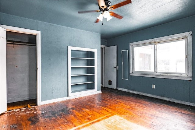 unfurnished bedroom featuring ceiling fan and hardwood / wood-style flooring