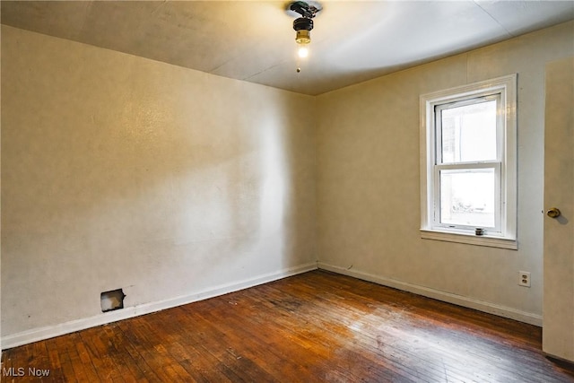 unfurnished room with dark hardwood / wood-style floors